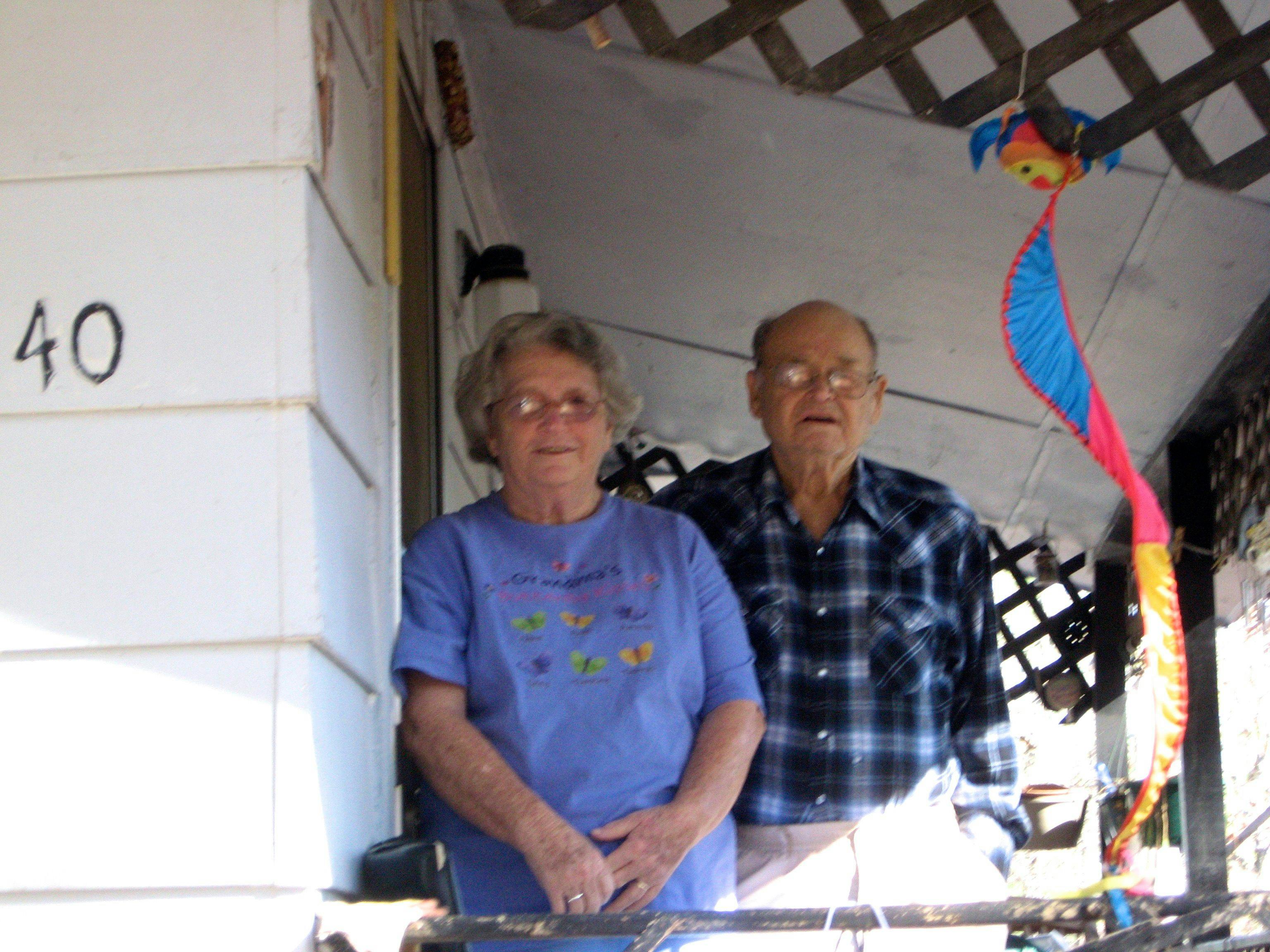 Casey's grandparents standing together on the porch of the house his grandpa.